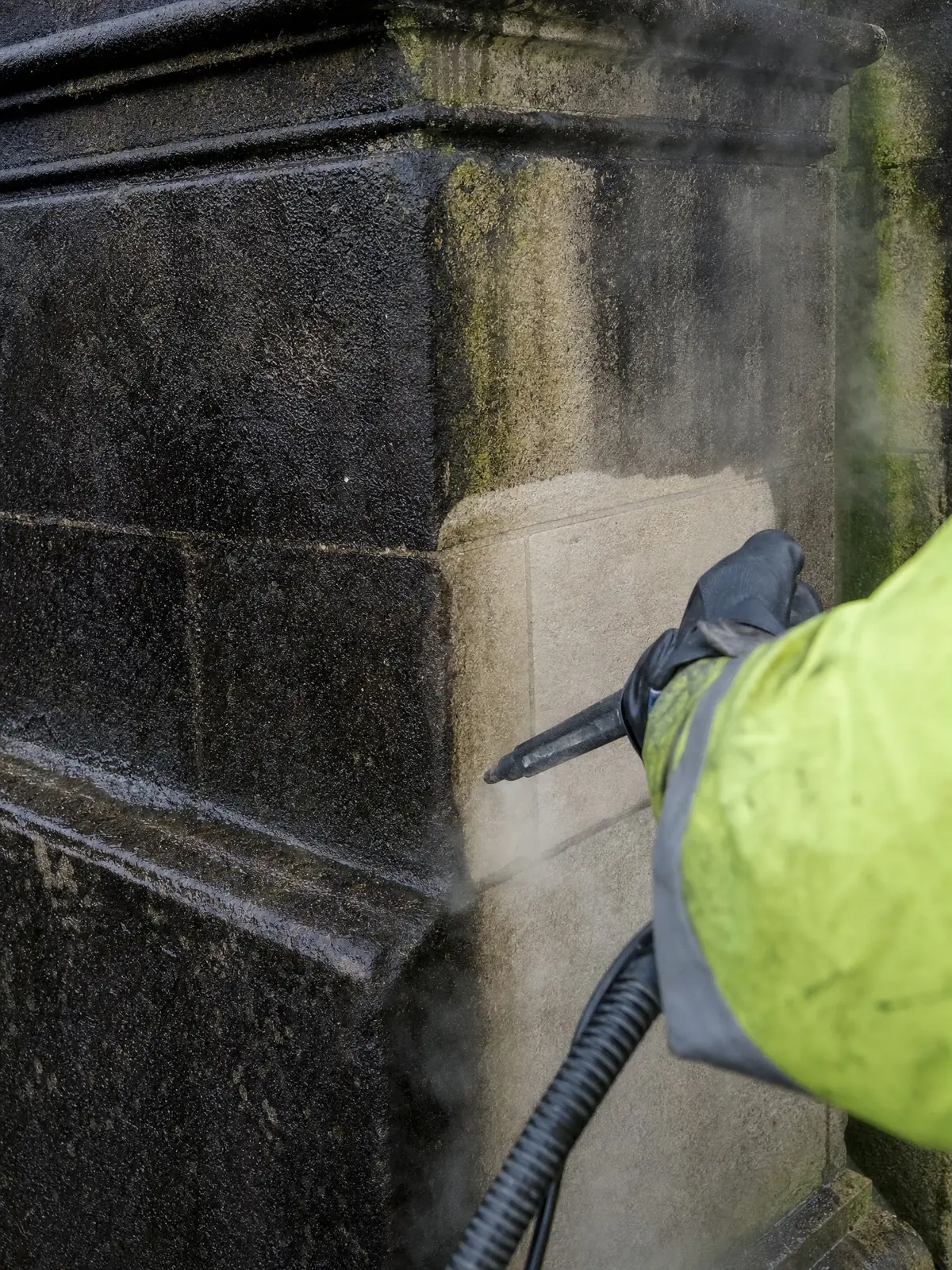 Close-up of soot and biological growth lifting off stone during DOFF cleaning