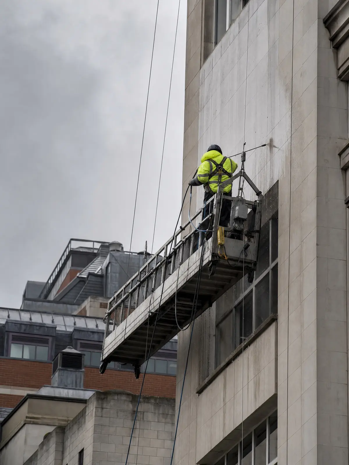 Cleaning the upper facade of a tall commercial building
