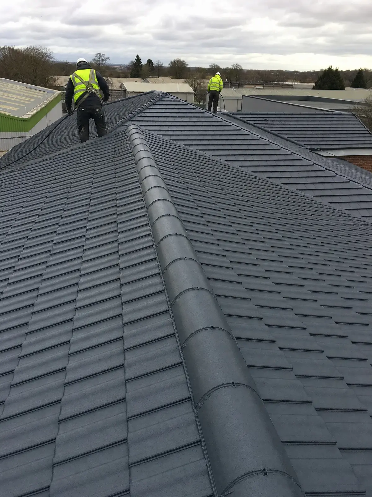 A commercial roof with a uniform fresh sprayed coating finish